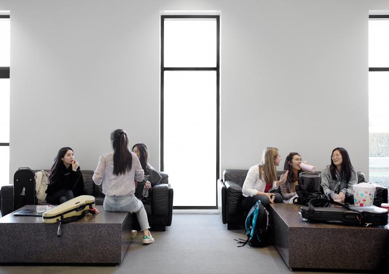 Student hanging out between classes in the East Lounge