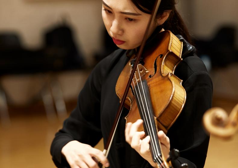 Student warming-up backstage before an orchestra performing