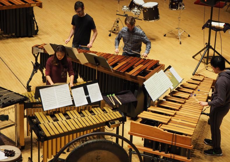 Students during Percussion Ensemble dress rehearsal on Stude Concert Stage