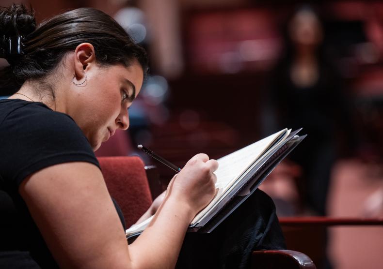 Student reviewing musical score