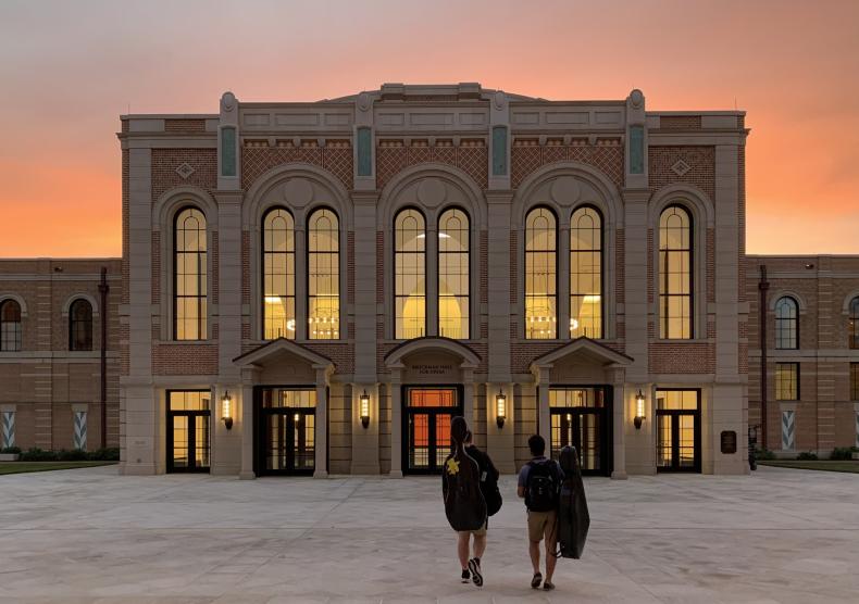 Two students walking toward Brockman Hall for Opera