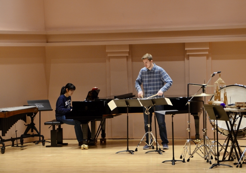 A pianist and percussionist perform together