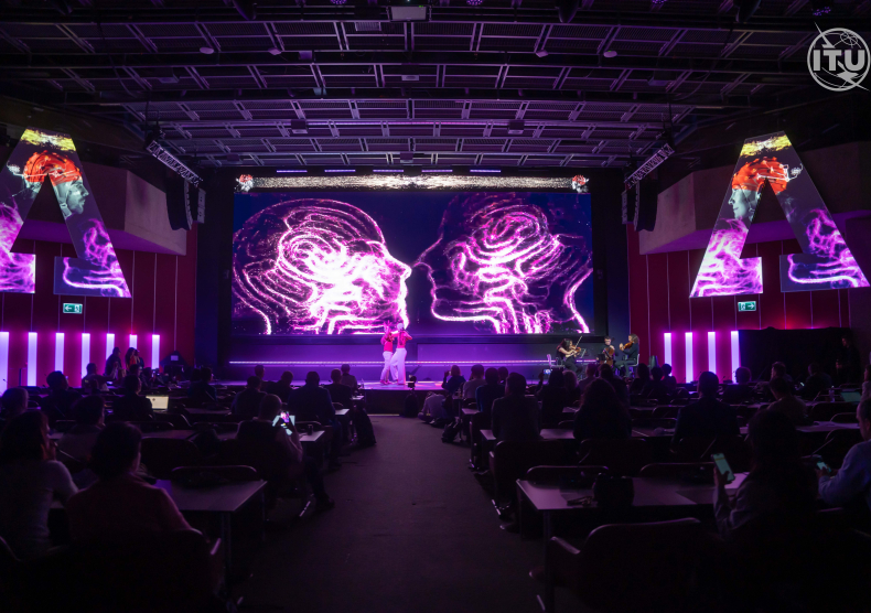 Performance photo of dancers on stage with a projection of brains in the background