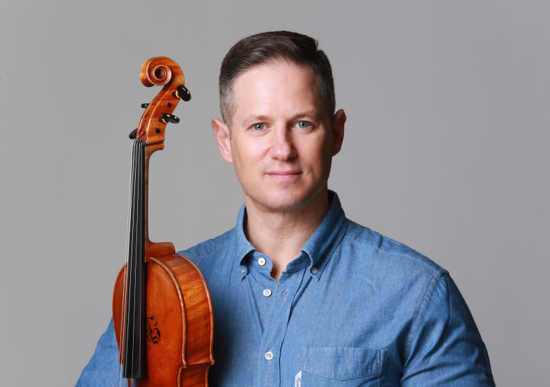 Ori Kam in blue shirt with viola