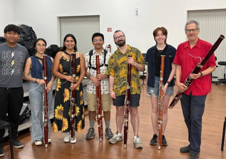 Professor Ben Kamins stands with a group of bassoon students